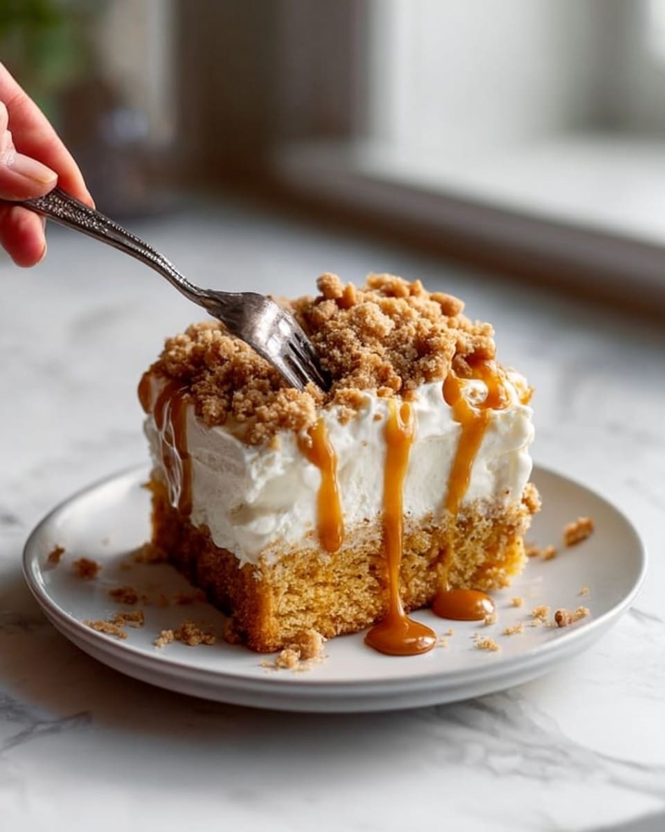 The image shows a square piece of cake on a white plate, placed on a white marbled surface. The bottom layer is a thick, moist, golden brown cake. On top of the cake is a thick layer of white, creamy frosting with a smooth texture. Caramel sauce is drizzled over the frosting, running down the sides. The top is covered with a crumbly topping that looks like crushed nuts or streusel, adding texture and color contrast. A woman's hand holding a fork is gently cutting into the cake from the right side. Photo taken with an iphone --ar 4:5 --v 7
