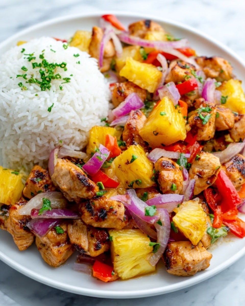 The image shows a close-up of a white plate with a colorful dish of grilled chicken pieces, bright yellow pineapple chunks, and red onion slices, all mixed with small bits of red and green bell peppers. The chicken is golden brown with grill marks, the pineapple looks juicy and fresh, and the vegetables add a vibrant mix of textures and colors. On the side of the plate is a mound of fluffy white rice garnished with small green herbs. The plate sits on a white marbled surface, giving the whole scene a clean and fresh look. Photo taken with an iphone --ar 4:5 --v 7