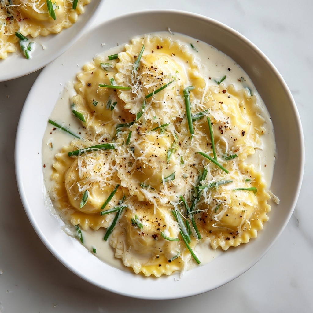 A white bowl filled with a single layer of round ravioli pasta with fluted edges, cooked to a soft yellow color, topped with a light coating of melted butter sauce that gives a shiny texture. The ravioli is sprinkled generously with finely grated white Parmesan cheese, small green chopped parsley pieces scattered evenly, and a few specks of cracked black pepper for contrast. The bowl sits on a white marbled surface, with a gray patterned cloth partially visible beside it. Photo taken with an iphone --ar 4:5 --v 7
