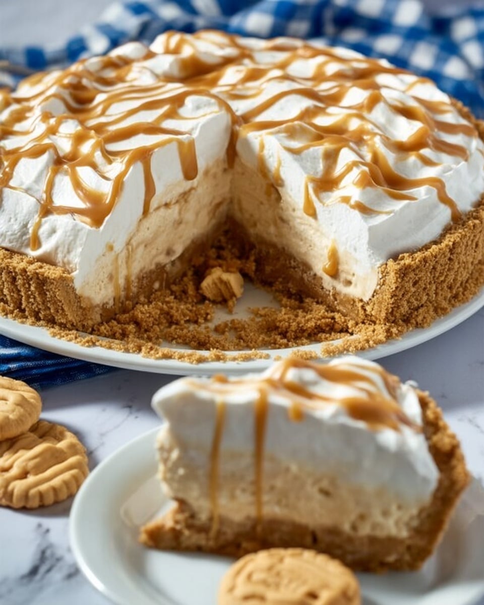 A slice of cake sits on a white plate with a blue checkered cloth underneath on a white marbled surface. The cake has three visible layers: a crumbly light brown crust at the bottom, a thick middle layer of creamy beige filling with small crunchy bits mixed in, and a thick, fluffy white topping layer. Drizzled over the top and sides is a smooth light brown caramel sauce. A round cookie with a crisscross pattern is placed upright behind the cake slice, and two more cookies lie flat on the plate beside it, while a fork rests next to the slice. In the background, the rest of the cake can be seen in a clear glass dish. Photo taken with an iphone --ar 4:5 --v 7