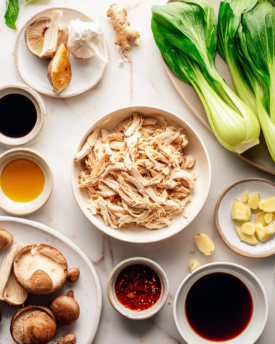 A close-up view of a bowl filled with a clear broth soup containing three main layers: at the bottom, yellow curly noodles forming a thick base, above them, shredded light brown chicken pieces spread unevenly, and scattered throughout are sliced bright orange carrots and green chopped scallions. The soup is topped with sesame seeds and small red chili slices, all inside a white speckled bowl resting on a white marbled surface with a textured brown cloth beside it. A silver spoon lifts some soup, noodles, chicken, and vegetables from the bowl. Photo taken with an iphone --ar 4:5 --v 7