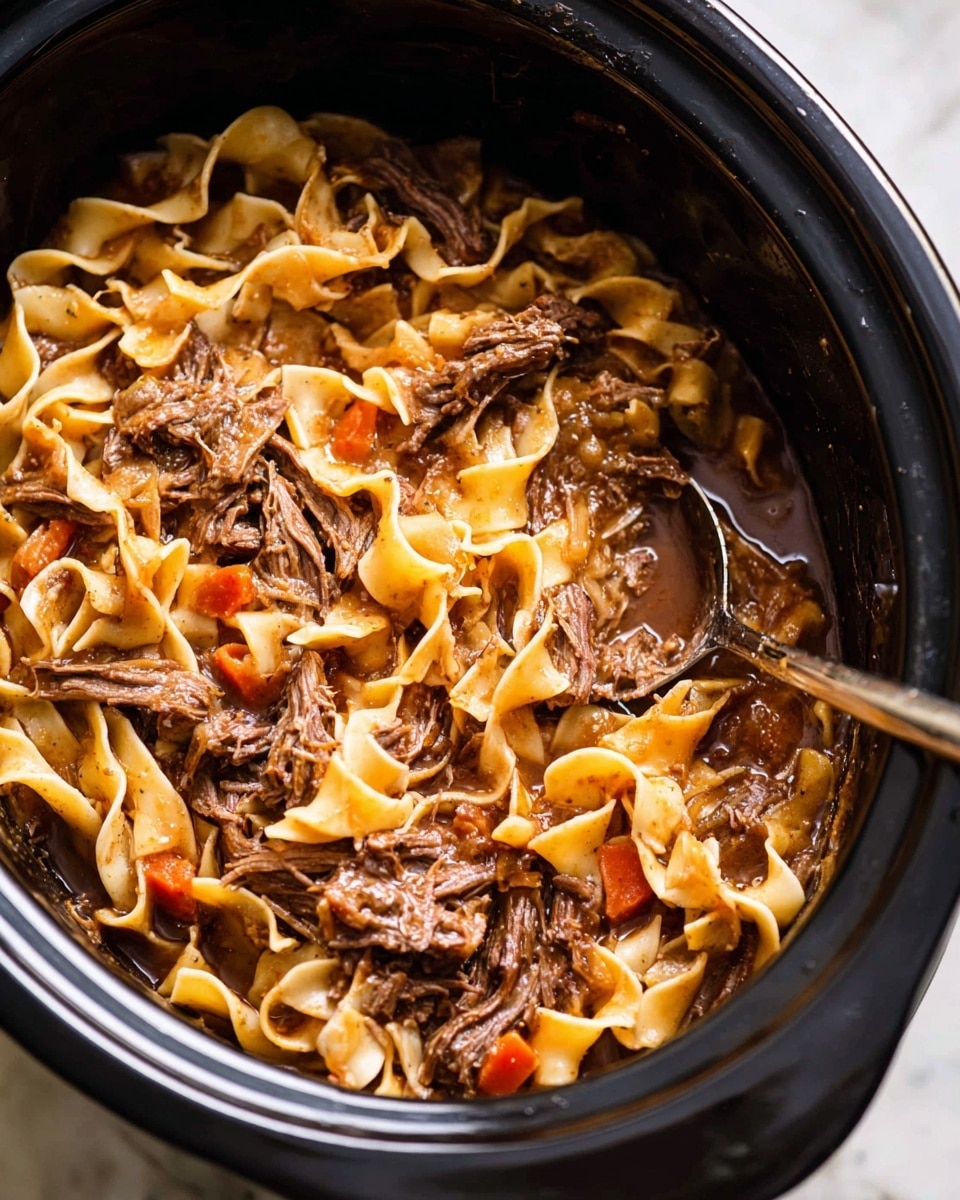 The image shows a white bowl filled with wide, flat pasta noodles that have a light yellow color and a slightly wrinkled texture. Mixed with the pasta are shredded brown meat pieces and small diced orange carrots and light green celery. The dish is sprinkled with small green herb bits, adding a fresh touch. A fork is lifting a portion of pasta, meat, and vegetables in the center. The bowl is placed on a white marbled surface with a glass of red drink nearby and a green and white checkered cloth at the bottom. photo taken with an iphone --ar 4:5 --v 7