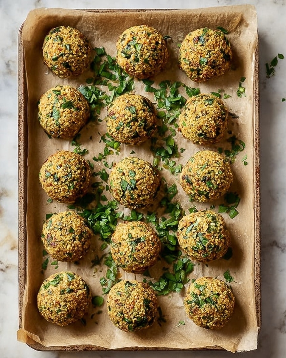 A white bowl is filled with about twelve round falafel balls that have a golden-brown, crispy texture with small green herb pieces visible on the surface. The falafel balls are stacked evenly, and some fresh green parsley leaves are sprinkled on top, adding a fresh touch. In the background, slightly out of focus, is a white bowl with a creamy white sauce garnished with small green herb pieces. The whole setup rests on a soft black and white textured cloth, with a white marbled surface beneath. Photo taken with an iphone --ar 4:5 --v 7